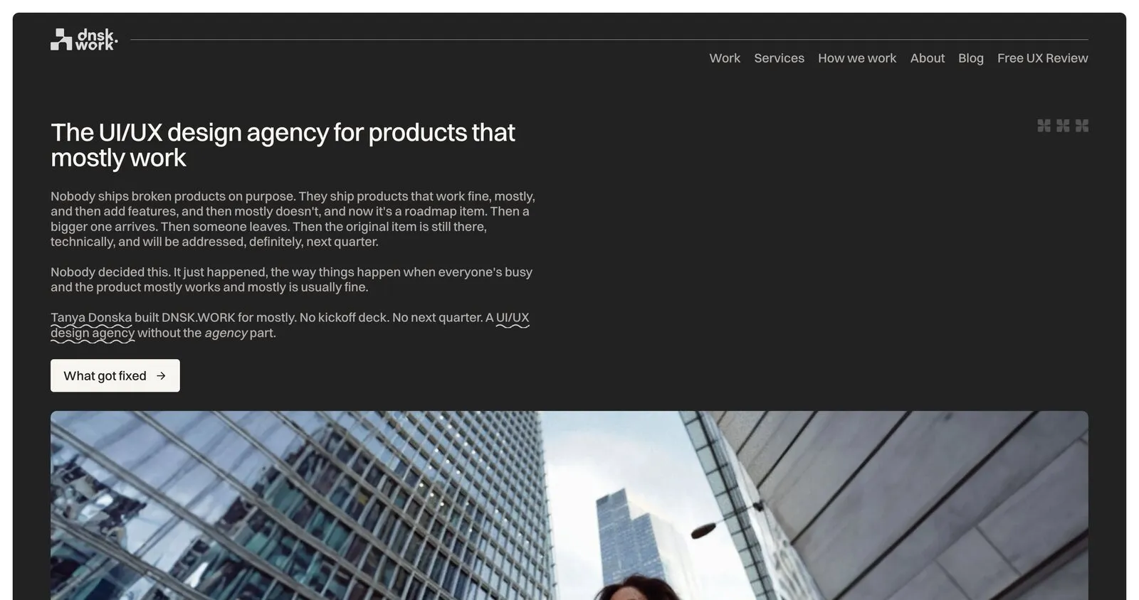 The DNSK.WORK home page: white type on near-black reading The UI/UX design agency for products that mostly work, above a photograph of a city block.