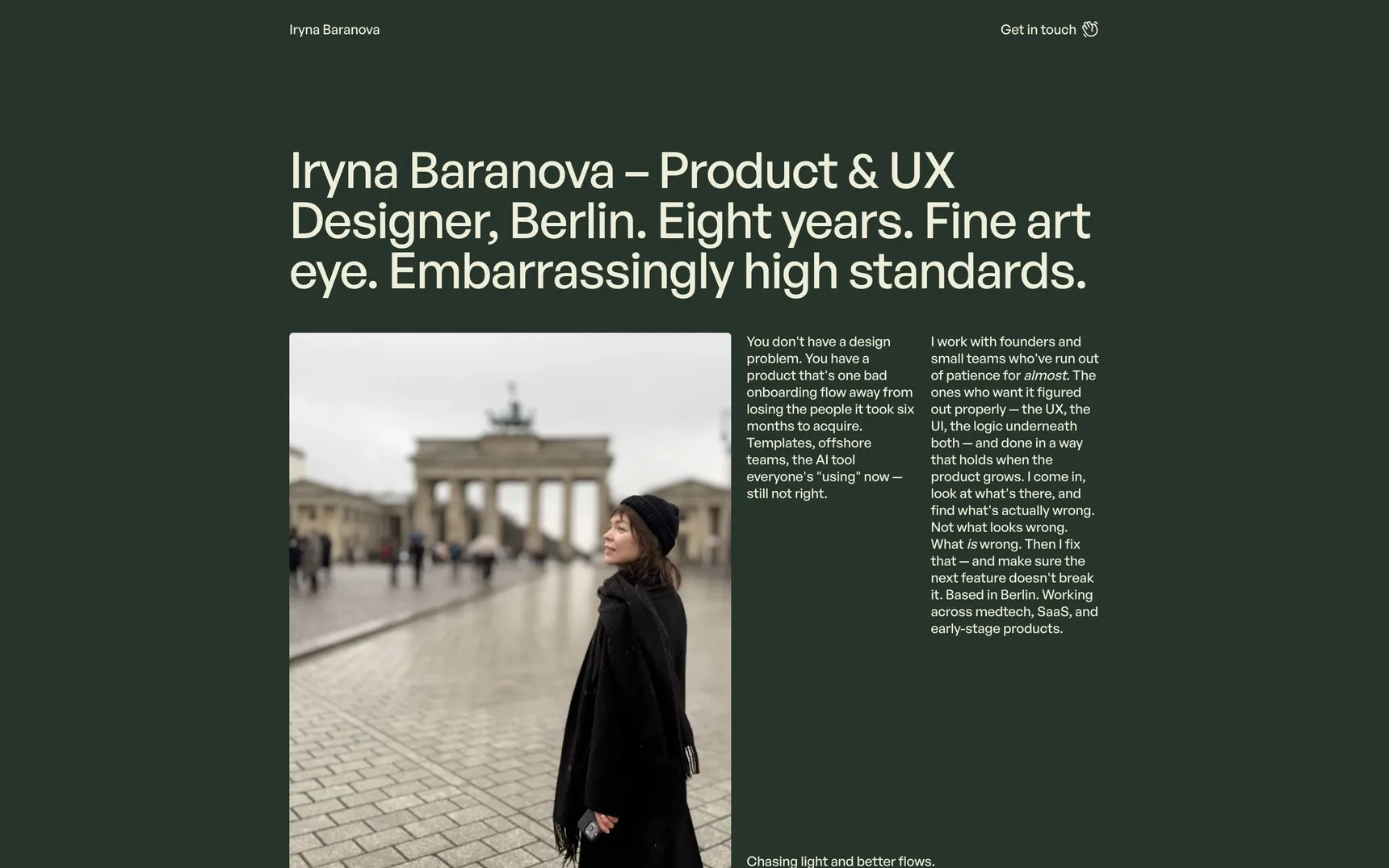 The Iryna Baranova home page: a dark green ground, a large cream headline reading Product & UX Designer, Berlin, and a photograph of her in front of the Brandenburg Gate.